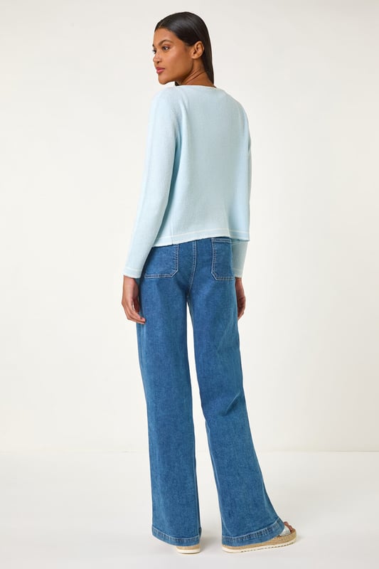 Faux Pearl Trim Cardigan from Roman. Add a touch of elegance to any outfit with this chic faux pearly detail cardigan. The perfect Spring/Summer cover-up, featuring long sleeves and an edge to edge front for effortless style. Layer over a floral dress and heels for a classic and sophisticated look.