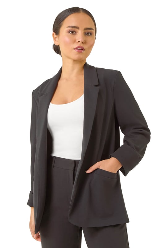 Petite Revere Collar Stretch Blazer Petite Revere Collar Stretch Blazer from Roman. Upgrade your Spring/Summer wardrobe with this chic stretch blazer. Effortlessly stylish, this blazer features a sophisticated revere collar and a pull-on style for easy wear. The long set-in sleeves with roll-up cuffs add a touch of versatility. Cut to a flattering hip-length in a comfortable stretch fabric, this blazer is the perfect choice for adding a smart touch to any outfit. Pair it with a floral dress and heels for a polished and put-together look.