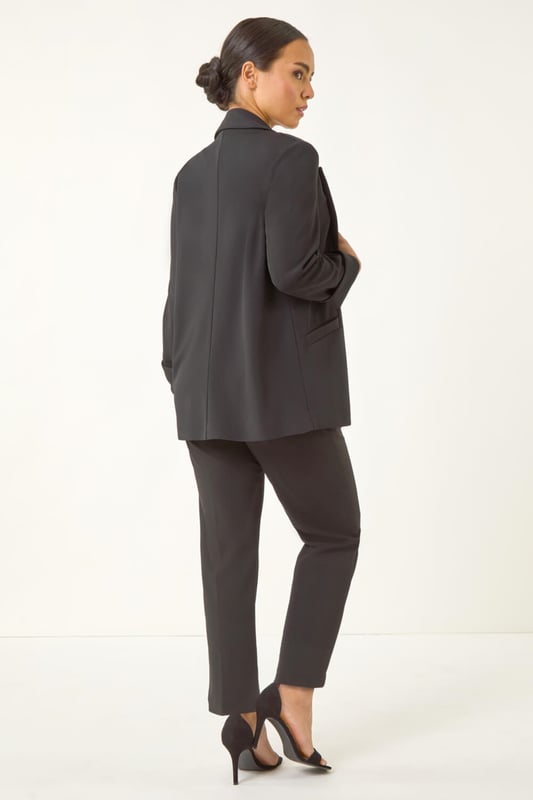 Petite Revere Collar Stretch Blazer Petite Revere Collar Stretch Blazer from Roman. Upgrade your Spring/Summer wardrobe with this chic stretch blazer. Effortlessly stylish, this blazer features a sophisticated revere collar and a pull-on style for easy wear. The long set-in sleeves with roll-up cuffs add a touch of versatility. Cut to a flattering hip-length in a comfortable stretch fabric, this blazer is the perfect choice for adding a smart touch to any outfit. Pair it with a floral dress and heels for a polished and put-together look.