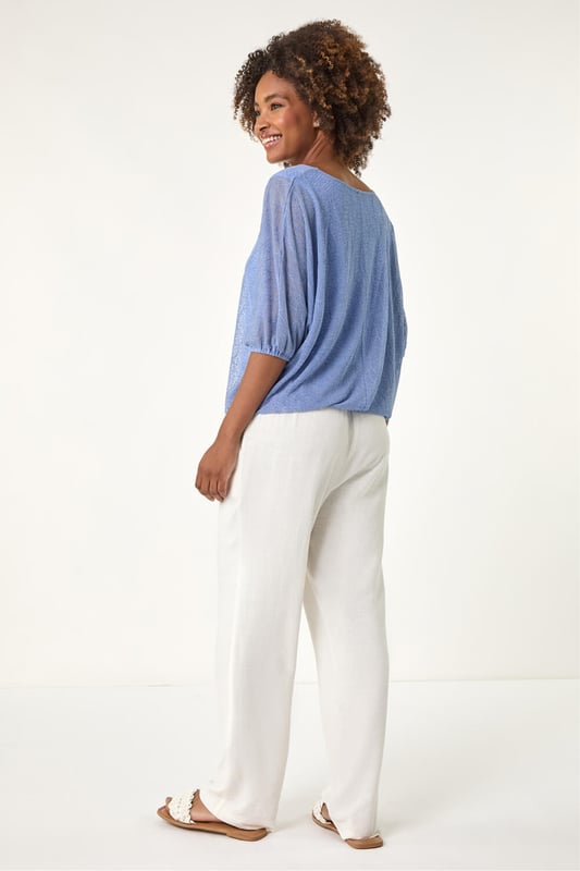 Mesh Bubble Hem Stretch Top from Roman. This stylish top is crafted from soft jersey fabric and features a round neckline and 3/4 sleeves for a comfortable fit. The bubble hem detail adds a playful and flattering touch, while the textured fabric gives it an extra layer of sophistication. Pair it effortlessly with jeans and sandals for a chic, relaxed look perfect for Spring or Summer outings.