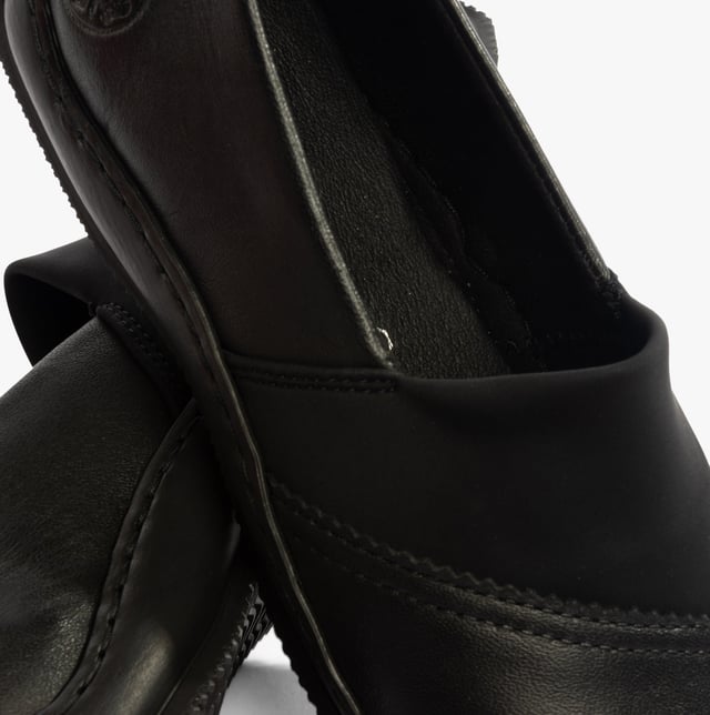 These casual slip-on shoes feature a leather upper, textile lining, and a lightweight RIRICON sole. Designed for comfort and breathability, ideal for everyday wear