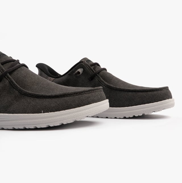 These casual men's shoes feature a canvas upper, textile lining, rubber sole, and slip-in design. They offer comfort with air-cooled memory foam and a relaxed fit for everyday wear