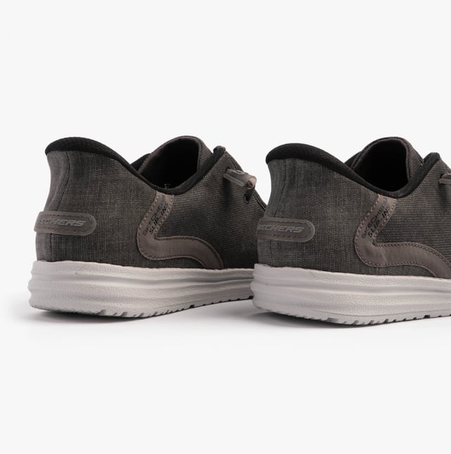 These casual men's shoes feature a canvas upper, textile lining, rubber sole, and slip-in design. They offer comfort with air-cooled memory foam and a relaxed fit for everyday wear