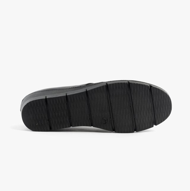 These casual women's slip-on shoes feature a leather upper, textile lining, rubber sole, and a low wedge heel, offering comfort and a wide fit for everyday wear