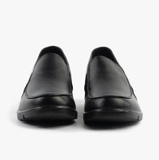 These casual women's slip-on shoes feature a leather upper, textile lining, rubber sole, and a low wedge heel, offering comfort and a wide fit for everyday wear