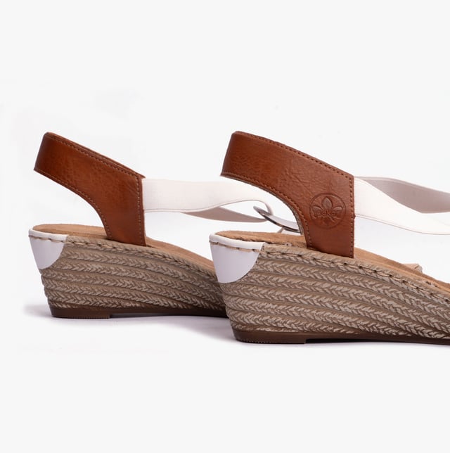 These women's slip-on wedge sandals feature a synthetic upper, breathable textile lining, and a RIRICON sole, offering comfort and a relaxed fit for casual wear