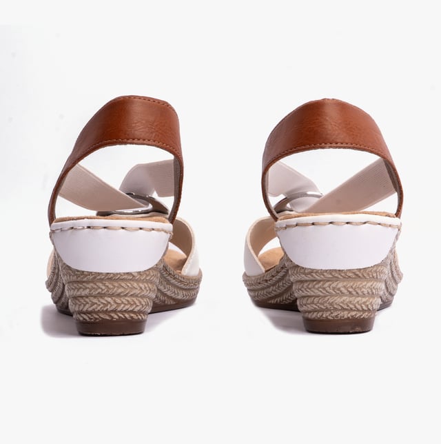 These women's slip-on wedge sandals feature a synthetic upper, breathable textile lining, and a RIRICON sole, offering comfort and a relaxed fit for casual wear
