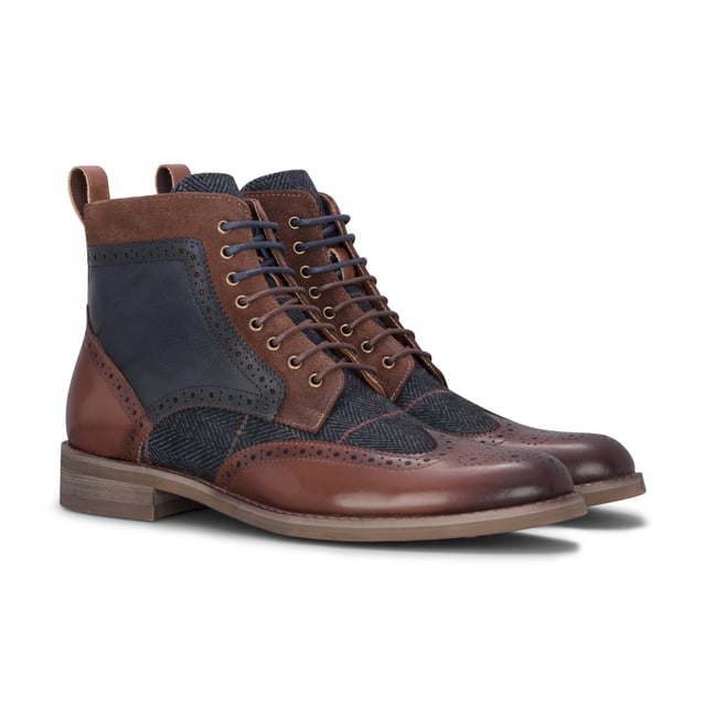 Refine your footwear collection with the Teddy Men's Brown Leather and Navy Tweed Oxford Shoes. Crafted from genuine leather with contrasting navy tweed panels, these shoes offer a perfect blend of traditional style and modern character. The Oxford silhouette provides a smart, structured shape, ideal for formal occasions or smart-casual outfits. A soft inner lining ensures comfort throughout the day, making them as wearable as they are stylish.

Premium Brown Leather Upper for a polished and durable finish

Contrasting Navy Tweed Panels add texture and a unique twist

Classic Oxford Design with a structured silhouette

Lace-Up Fastening ensures a secure and adjustable fit

Soft Inner Lining for comfort during extended wear

Stitched Detailing for added craftsmanship and style

Ideal for Smart-Casual to Formal Events — weddings, work, or evening outings