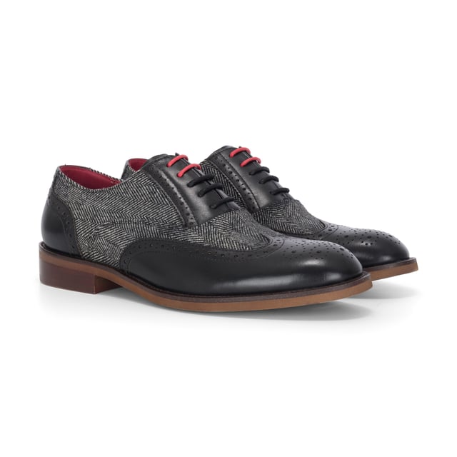 Make a refined impression with the Justin Reess Albert Black Leather Brogues. Blending smooth leather with textured tweed, these formal shoes offer a smart twist on a classic style. Perfect for weddings, work events, or evenings out, they combine comfort, detail, and durability in one polished design.

Black Leather Upper for a sleek, timeless look

Tweed Fabric Panels add texture and unique style

Classic Brogue Detailing with wingtip accents

Lace-Up Fastening for a secure and adjustable fit

Cushioned Insole for enhanced comfort during long wear

Durable Sole for traction and longevity

Perfect for Formal Events, business attire, or smart-casual outfits