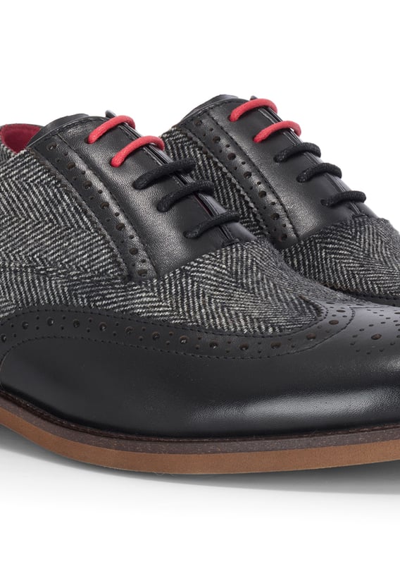 Make a refined impression with the Justin Reess Albert Black Leather Brogues. Blending smooth leather with textured tweed, these formal shoes offer a smart twist on a classic style. Perfect for weddings, work events, or evenings out, they combine comfort, detail, and durability in one polished design.

Black Leather Upper for a sleek, timeless look

Tweed Fabric Panels add texture and unique style

Classic Brogue Detailing with wingtip accents

Lace-Up Fastening for a secure and adjustable fit

Cushioned Insole for enhanced comfort during long wear

Durable Sole for traction and longevity

Perfect for Formal Events, business attire, or smart-casual outfits