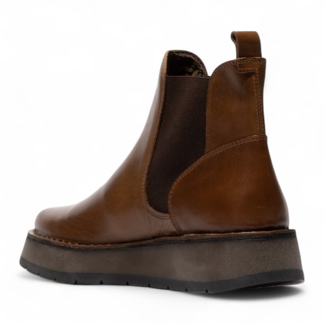 The Fly London RAWI131 Chelsea boots from the Rawi Line blend timeless style with modern comfort. Designed for effortless everyday wear, these ankle boots feature a convenient pull-on design with elasticated side panels. Crafted from premium leather, they offer a soft microfiber lining and cushioned microfiber insole for lasting comfort. The durable TR rubber sole provides reliable grip and support, while the 3.5 cm heel adds a subtle lift without compromising stability. Perfect for both casual and smart-casual looks, these Chelsea boots are a versatile wardrobe essential.

Upper: Leather
Lining: Microfiber
Insole: Microfiber
Sole: TR Rubber
Heel Height: 3.5 cm
Style: Pull-on Chelsea