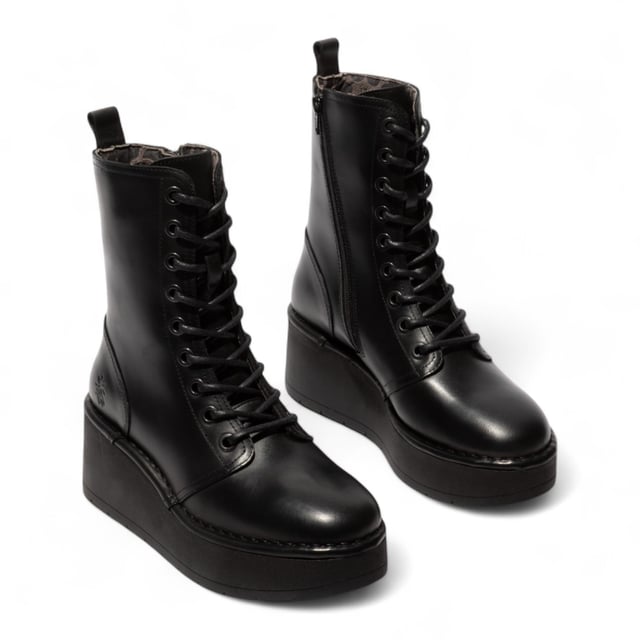 Add bold comfort to your wardrobe with the Fly London HAIT273 ankle boots. Crafted from premium leather and lined with soft microfiber, these lace-up boots are built for everyday wear with a fashion-forward edge. A side zip makes slipping them on easy, while the foam-padded footbed offers cushioned support. Set on a chunky 3-inch rubber wedge platform, they deliver excellent grip, traction, and elevation without sacrificing comfort.

Upper: Premium Leather
Lining: Microfiber
Insole: Foam-padded, microfiber-lined
Sole: Durable Rubber platform
Closure: Lace-up with side zip
Heel Height: 3 inches (approx. 7.6 cm)
Style: Chunky platform ankle boots
Features: Cushioned footbed, great grip & traction, ideal for all-day wear
