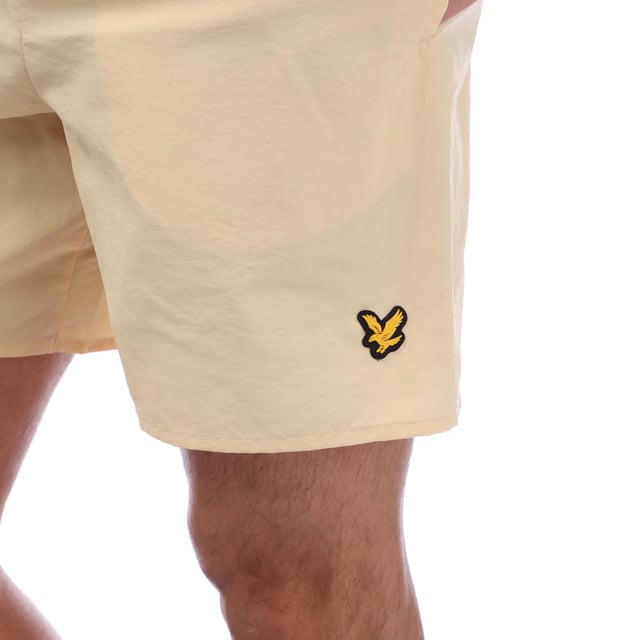 Mens Lyle And Scott Sports Swim Shorts in sand.- Elasticated waistband.- Side slip pockets.- Back flap pocket.- Rubberised logo.- Breathable  lightweight fabric.- Body: 100% Polyamide. Lining: 100% Polyester.- Ref: SH1266SPBX183