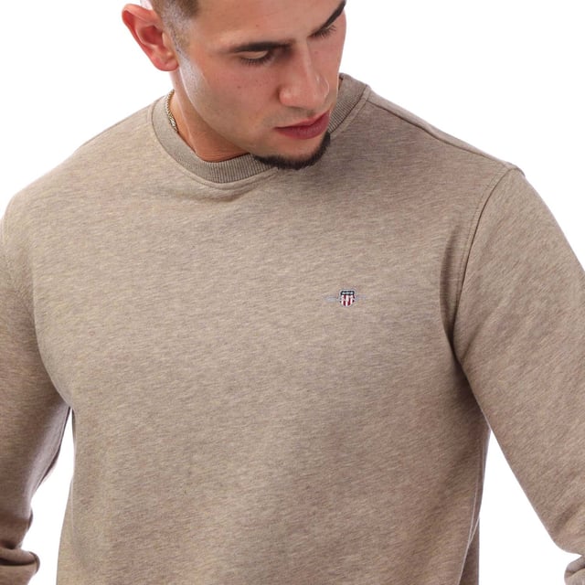 Crafted from a soft cotton blend  this GANT sweatshirt is designed for a regular fit. A simple yet modern design  it features ribbed detailing and GANT's iconic shield graphic embroidered at the chest. Style with the matching GANT sweatpants for a cozy  coordinated set. By choosing our cotton products  you’re supporting GANT's investment in Better Cotton’s mission. This product is sourced via a system of mass balance and therefore may not contain Better Cotton. Read more on bettercotton.org-massbalance