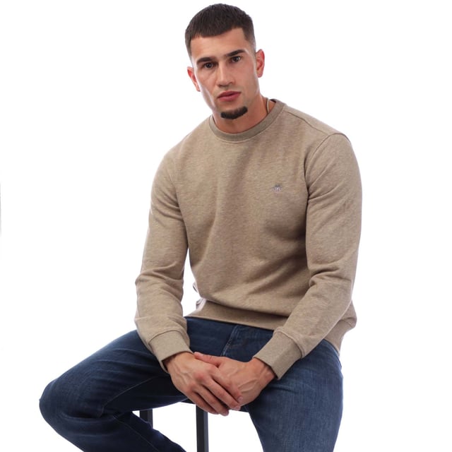 Crafted from a soft cotton blend  this GANT sweatshirt is designed for a regular fit. A simple yet modern design  it features ribbed detailing and GANT's iconic shield graphic embroidered at the chest. Style with the matching GANT sweatpants for a cozy  coordinated set. By choosing our cotton products  you’re supporting GANT's investment in Better Cotton’s mission. This product is sourced via a system of mass balance and therefore may not contain Better Cotton. Read more on bettercotton.org-massbalance