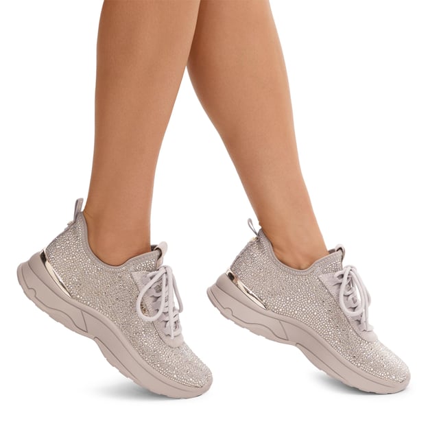 This Carvela Swift Jewel Runner trainer features a taupe fabric upper with gold crystal embellishment. The front laces up with gold tone branding on the eye stay.