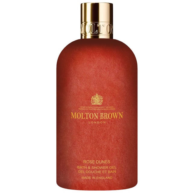 Immerse yourself in the enchanting allure of the desert with the Molton Brown Rose Dunes Bath & Shower Gel. This exquisite gel opens with a captivating blend of saffron and cassis, evoking the warmth of a desert breeze. Its heart is delicately infused with tender rose notes harmoniously intertwined with geranium, while the base reveals a rich and luxurious oudh finish. Experience a lavish cleansing ritual that transforms your bath or shower into a sensory oasis. Plus, enjoy peace of mind knowing that Molton Brown is a Leaping Bunny-approved cruelty-free brand.
