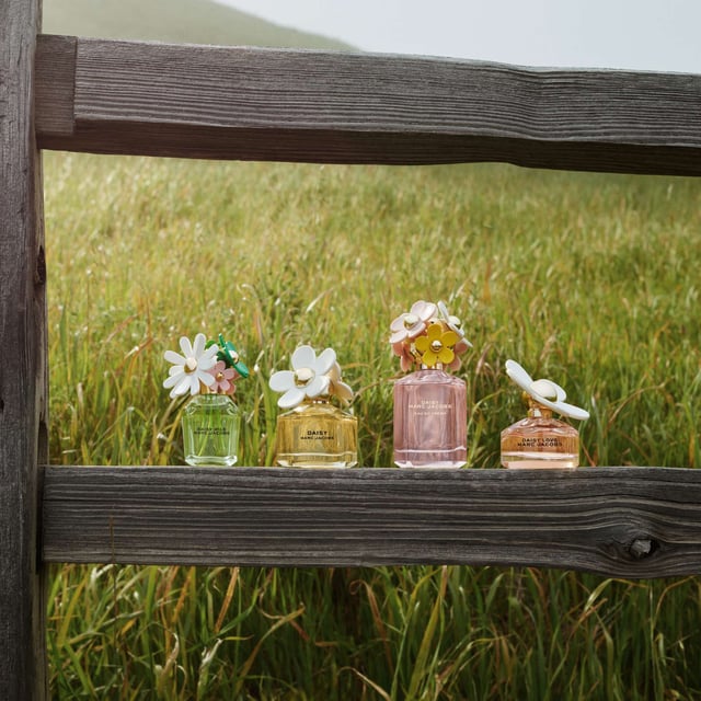 Discover the enchanting allure of Marc Jacobs Daisy Eau de Toilette, a fragrance that embodies optimism and beauty. This delightful scent opens with fresh wild berries and soft white violets, leading to a heart of velvety jasmine that transitions into a warm drydown of sensual sandalwood. Created by Master Perfumer Alberto Morillas, this captivating perfume is housed in a whimsical bottle adorned with charming daisies, making it as unique as the woman who wears it. Please note, we cannot ship fragrances over 150ml outside of the UK.
