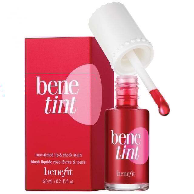 Experience the ultimate rosy glow with Benefit Benetint, the original lip and cheek stain that delivers a sexy flush in seconds. Created for an exotic dancer in the 1970s, this cult-favorite product offers a sheer, buildable color that lasts for hours without smudging or drying out. The convenient doe foot applicator makes it easy to apply on lips and cheeks for a stunning look. Perfect for all-day wear, layer with your favorite gloss for a more intense pout. Join the countless celebrities and makeup artists who adore this timeless beauty staple!