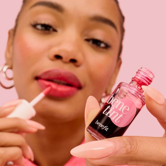 Experience the ultimate rosy glow with Benefit Benetint, the original lip and cheek stain that delivers a sexy flush in seconds. Created for an exotic dancer in the 1970s, this cult-favorite product offers a sheer, buildable color that lasts for hours without smudging or drying out. The convenient doe foot applicator makes it easy to apply on lips and cheeks for a stunning look. Perfect for all-day wear, layer with your favorite gloss for a more intense pout. Join the countless celebrities and makeup artists who adore this timeless beauty staple!