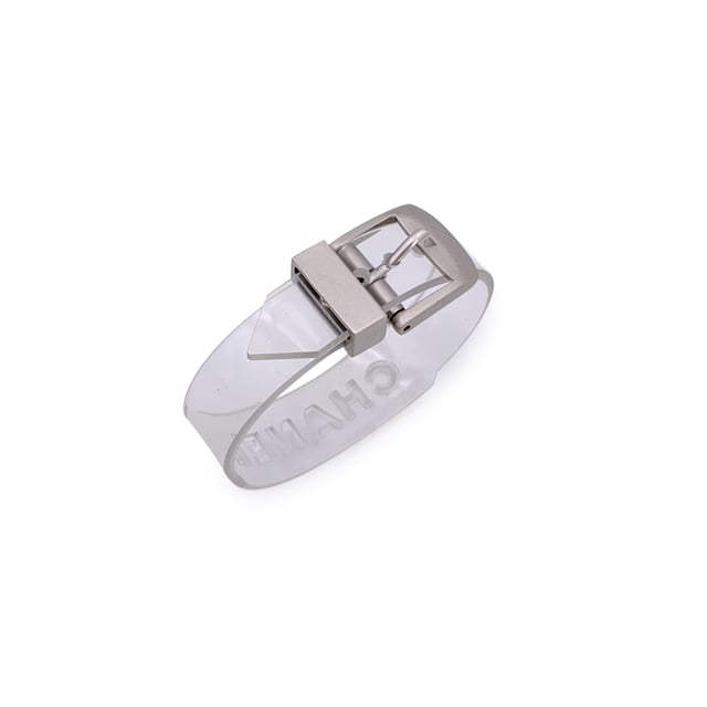 VINTAGE, RRP AS NEW
Add a playful twist of luxury to your collection with this lovely CHANEL bracelet, a rare and striking piece that fuses bold branding with unexpected materials. Crafted in clear transparent rubber, it's a standout example of late '90s CHANEL design-where classic elegance met avant-garde edge.  The bracelet features cut-out CHANEL lettering that runs boldly across its surface, allowing light to pass through for a modern, sculptural look. A buckle closure adds an industrial-chic touch, keeping the fit secure and adjustable.  Stamped with the 'Chanel 99 CC S Made in France' hallmark near the closure, this piece dates to 1999, offering collectors a glimpse into one of the brand's more experimental eras. At 8.25 inches (21 cm) in total length, it's designed to fit comfortably on most wrists.  Whether worn solo as a statement or layered with fine bangles for contrast, this bracelet is a perfect blend of vintage charm and futuristic flair-unmistakably CHANEL, and effortlessly cool. Condition Rating: A - EXCELLENTCondition Details: Minimal wear of use on rubber. Please, look carefully at the photos and ask for any detail.  Box?: ?: No Measurments:  length: 210 mm