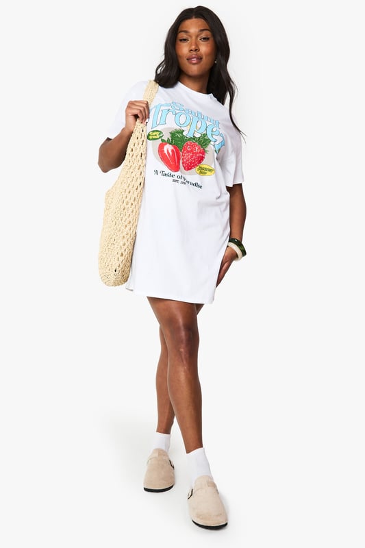 Oversized T-shirt dress featuring a vibrant Saint Tropez strawberry graphic print
        Relaxed crew neckline and short sleeves for effortless comfort
        Cotton fabric offers breathable wear perfect for warmer days
        Versatile mini length ideal for casual styling
        Plus size design with a roomy, comfortable fit
    
    This playful Saint Tropez graphic T-shirt dress from Boohoo brings carefree holiday vibes to your everyday wardrobe. The oversized silhouette creates a relaxed look that's both comfortable and on-trend. Style it as seen with ankle boots and a woven tote for farmers' markets and weekend brunches, or pair with trainers and a denim jacket for casual coffee dates. For festival season, add chunky jewellery and wellies for an effortlessly cool ensemble. The versatile design works brilliantly with leggings underneath during transitional weather, while the cotton composition ensures all-day comfort. This T-shirt dress embodies the laid-back aesthetic that's perfect for casual gatherings and daytime outings when you want to combine comfort with personality.