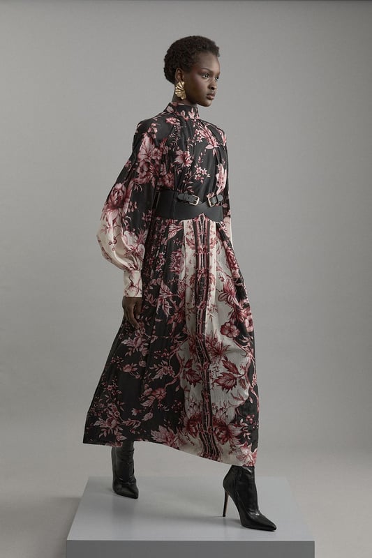 Silk Cotton Border Print Floral Woven Maxi Dress Step out in confidence in our long sleeve dress, which is made with slinky silk, and features a relaxed fit and long, balloon style sleeves. The bold, floral print adds a feminine touch ideal for any occasion, and the bow behind the neck elevates it even further. This dress can easily be paired with boots or heels for a day to night look. Silk Cotton Border Print Floral Woven Maxi Dress High Quality, Smooth Silk Fabric Comfortable, Relaxed Silhouette High Neckline Vibrant Floral Print Long Balloon Sleeves Bow Accent in Back