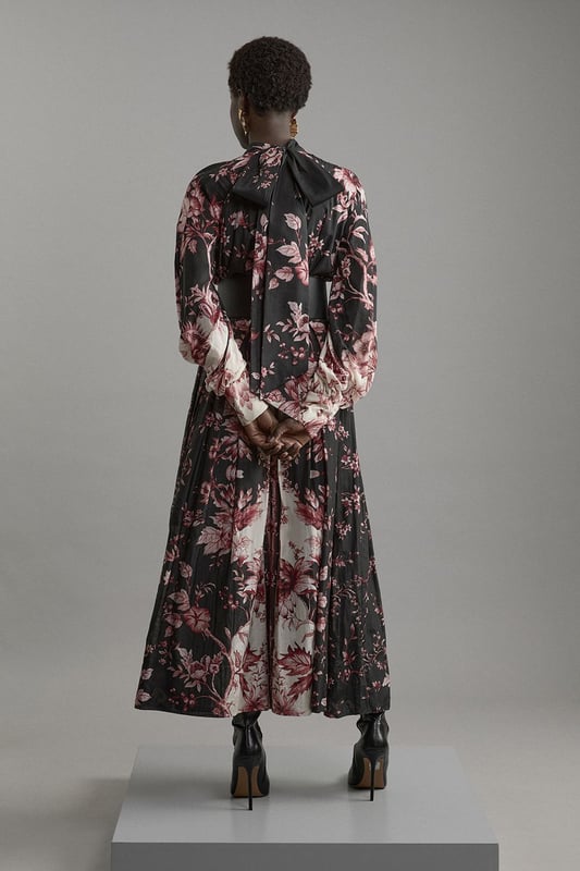 Silk Cotton Border Print Floral Woven Maxi Dress Step out in confidence in our long sleeve dress, which is made with slinky silk, and features a relaxed fit and long, balloon style sleeves. The bold, floral print adds a feminine touch ideal for any occasion, and the bow behind the neck elevates it even further. This dress can easily be paired with boots or heels for a day to night look. Silk Cotton Border Print Floral Woven Maxi Dress High Quality, Smooth Silk Fabric Comfortable, Relaxed Silhouette High Neckline Vibrant Floral Print Long Balloon Sleeves Bow Accent in Back