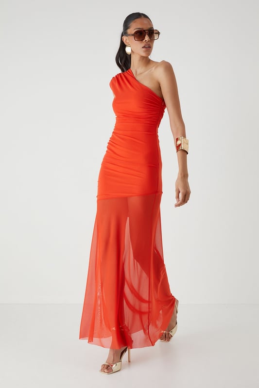 Striking one-shoulder design with elegant ruched detailing
        Figure-flattering jersey fabric with strategic ruching across the bodice
        Dramatic maxi length with sheer mesh overlay from mid-thigh
        Body-contouring silhouette that accentuates your curves
        Lined construction for comfort and coverage where needed
    
    Make a showstopping entrance in this captivating mesh ruched one-shoulder maxi dress from MissPap. The asymmetric neckline creates a bold statement whilst the expertly placed ruching works to flatter your figure. The dress transitions beautifully from a fitted bodice to a flowing sheer mesh skirt, creating a tantalising glimpse of leg whilst maintaining an air of sophistication. Style with strappy heels and statement jewellery as seen on our model for formal occasions such as weddings or galas. For evening events, add a structured clutch and sleek updo to highlight the dramatic neckline. This dress commands attention whilst offering versatility - a true wardrobe hero piece for those moments when you want all eyes on you.