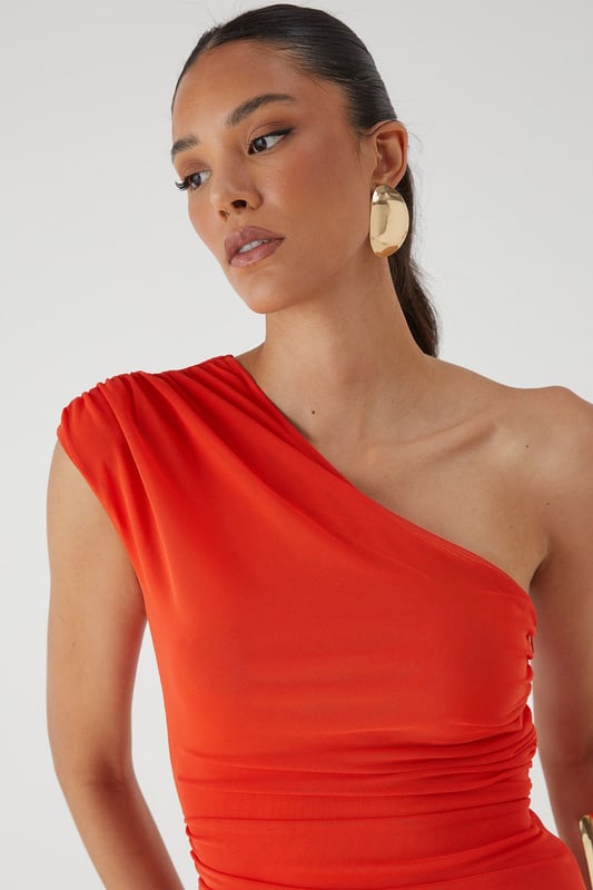 Striking one-shoulder design with elegant ruched detailing
        Figure-flattering jersey fabric with strategic ruching across the bodice
        Dramatic maxi length with sheer mesh overlay from mid-thigh
        Body-contouring silhouette that accentuates your curves
        Lined construction for comfort and coverage where needed
    
    Make a showstopping entrance in this captivating mesh ruched one-shoulder maxi dress from MissPap. The asymmetric neckline creates a bold statement whilst the expertly placed ruching works to flatter your figure. The dress transitions beautifully from a fitted bodice to a flowing sheer mesh skirt, creating a tantalising glimpse of leg whilst maintaining an air of sophistication. Style with strappy heels and statement jewellery as seen on our model for formal occasions such as weddings or galas. For evening events, add a structured clutch and sleek updo to highlight the dramatic neckline. This dress commands attention whilst offering versatility - a true wardrobe hero piece for those moments when you want all eyes on you.
