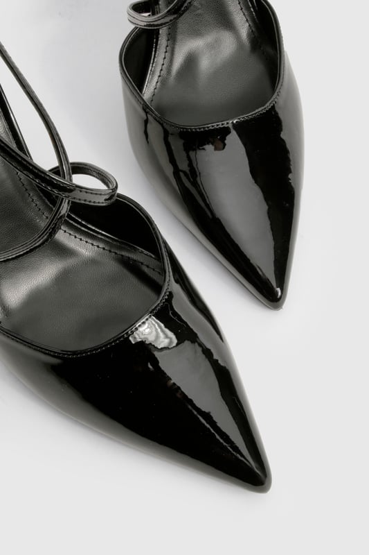 Striking cross-strap design adds contemporary flair to these pointed-toe court shoes
        High 7-9cm stiletto heel creates a leg-lengthening effect
        Glossy finish catches the light for added drama
        Pointed toe silhouette offers a timeless, sophisticated profile
        Adjustable ankle strap with buckle fastening ensures a secure fit
    
    These cross-strap court shoes are the perfect blend of modern design and classic elegance. The distinctive strappy detail creates visual interest while maintaining a sleek silhouette that works beautifully for various occasions. Style them with tailored trousers and a crisp blouse for office sophistication, or pair with your favourite little black dress for evening events. The pointed toe and high heel create a flattering line that elongates your legs, whilst the secure cross-straps provide stability without sacrificing style. These versatile heels transition effortlessly from day to night, making them an essential addition to your footwear collection. For weekend glamour, team with straight-leg jeans and a statement top to showcase their eye-catching design. A true wardrobe hero that delivers both comfort and head-turning style.