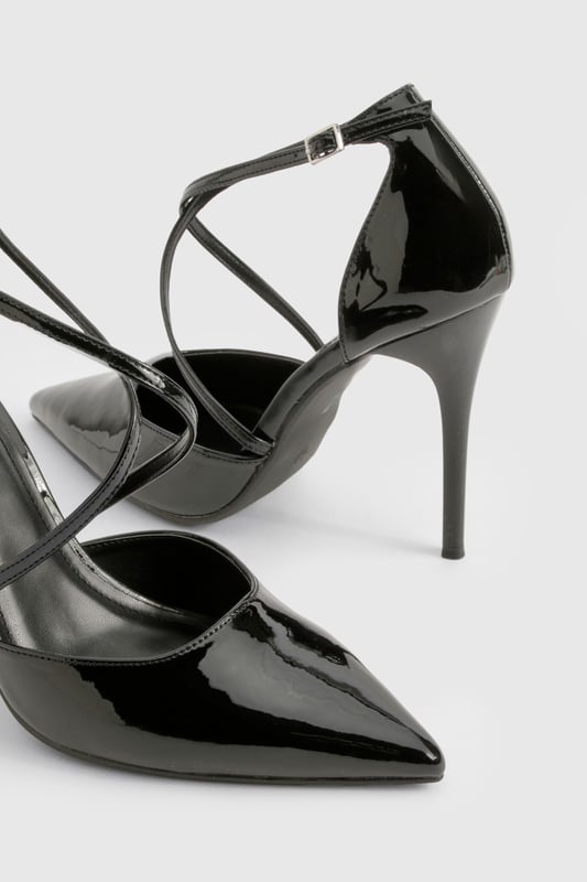 Striking cross-strap design adds contemporary flair to these pointed-toe court shoes
        High 7-9cm stiletto heel creates a leg-lengthening effect
        Glossy finish catches the light for added drama
        Pointed toe silhouette offers a timeless, sophisticated profile
        Adjustable ankle strap with buckle fastening ensures a secure fit
    
    These cross-strap court shoes are the perfect blend of modern design and classic elegance. The distinctive strappy detail creates visual interest while maintaining a sleek silhouette that works beautifully for various occasions. Style them with tailored trousers and a crisp blouse for office sophistication, or pair with your favourite little black dress for evening events. The pointed toe and high heel create a flattering line that elongates your legs, whilst the secure cross-straps provide stability without sacrificing style. These versatile heels transition effortlessly from day to night, making them an essential addition to your footwear collection. For weekend glamour, team with straight-leg jeans and a statement top to showcase their eye-catching design. A true wardrobe hero that delivers both comfort and head-turning style.