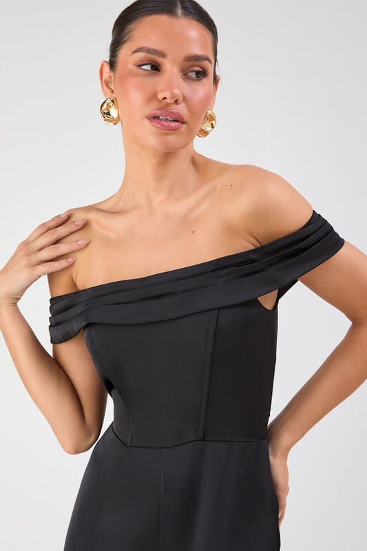 Elegant Bardot neckline with sophisticated folded detail for a striking off-shoulder silhouette
        Luxurious satin fabric that catches the light beautifully as you move
        Flattering structured bodice that enhances your natural shape
        Dramatic wide leg design offering both comfort and statement style
        Floor-sweeping length perfect for creating a statuesque appearance
    
    Command attention at your next special occasion in this show-stopping Misspap jumpsuit. The striking Bardot neckline frames your dcolletage whilst the structured bodice creates a flattering silhouette that transitions into flowing wide legs for dramatic effect. Style with statement earrings and sleek heels as seen on our model for maximum impact at formal events. This versatile piece works brilliantly for weddings, graduation ceremonies or evening soires - simply switch up your accessories to suit the occasion. For cooler evenings, layer with a tailored blazer or delicate wrap without compromising on glamour. The all-in-one design offers effortless sophistication whilst ensuring you stand out from the crowd.