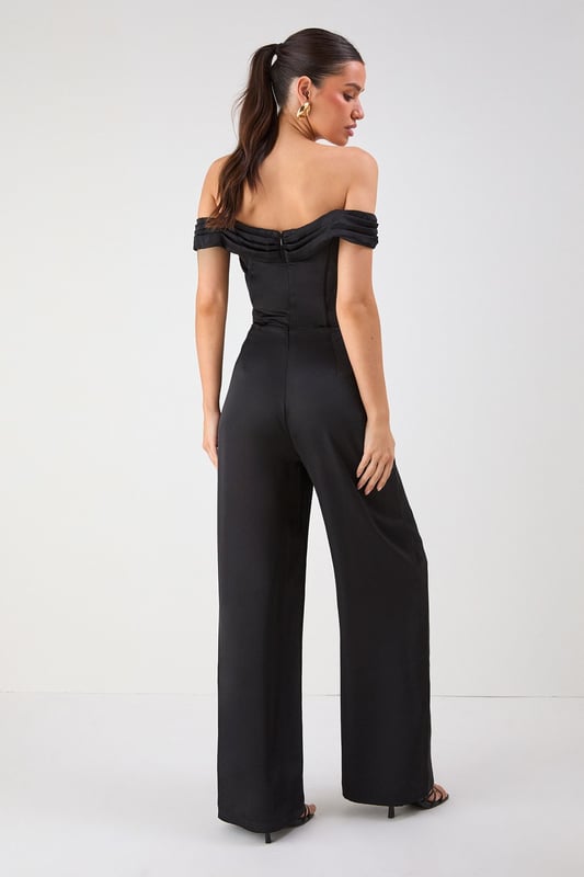 Elegant Bardot neckline with sophisticated folded detail for a striking off-shoulder silhouette
        Luxurious satin fabric that catches the light beautifully as you move
        Flattering structured bodice that enhances your natural shape
        Dramatic wide leg design offering both comfort and statement style
        Floor-sweeping length perfect for creating a statuesque appearance
    
    Command attention at your next special occasion in this show-stopping Misspap jumpsuit. The striking Bardot neckline frames your dcolletage whilst the structured bodice creates a flattering silhouette that transitions into flowing wide legs for dramatic effect. Style with statement earrings and sleek heels as seen on our model for maximum impact at formal events. This versatile piece works brilliantly for weddings, graduation ceremonies or evening soires - simply switch up your accessories to suit the occasion. For cooler evenings, layer with a tailored blazer or delicate wrap without compromising on glamour. The all-in-one design offers effortless sophistication whilst ensuring you stand out from the crowd.