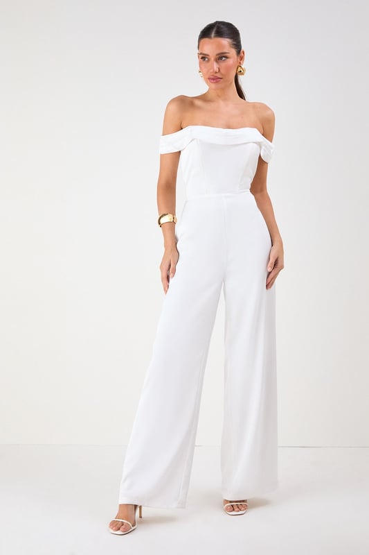 Elegant Bardot neckline with sophisticated folded detail for a striking off-shoulder silhouette
        Luxurious satin fabric that catches the light beautifully as you move
        Flattering structured bodice that enhances your natural shape
        Dramatic wide leg design offering both comfort and statement style
        Floor-sweeping length perfect for creating a statuesque appearance
    
    Command attention at your next special occasion in this show-stopping Misspap jumpsuit. The striking Bardot neckline frames your dcolletage whilst the structured bodice creates a flattering silhouette that transitions into flowing wide legs for dramatic effect. Style with statement earrings and sleek heels as seen on our model for maximum impact at formal events. This versatile piece works brilliantly for weddings, graduation ceremonies or evening soires - simply switch up your accessories to suit the occasion. For cooler evenings, layer with a tailored blazer or delicate wrap without compromising on glamour. The all-in-one design offers effortless sophistication whilst ensuring you stand out from the crowd.