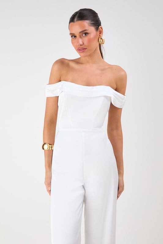 Elegant Bardot neckline with sophisticated folded detail for a striking off-shoulder silhouette
        Luxurious satin fabric that catches the light beautifully as you move
        Flattering structured bodice that enhances your natural shape
        Dramatic wide leg design offering both comfort and statement style
        Floor-sweeping length perfect for creating a statuesque appearance
    
    Command attention at your next special occasion in this show-stopping Misspap jumpsuit. The striking Bardot neckline frames your dcolletage whilst the structured bodice creates a flattering silhouette that transitions into flowing wide legs for dramatic effect. Style with statement earrings and sleek heels as seen on our model for maximum impact at formal events. This versatile piece works brilliantly for weddings, graduation ceremonies or evening soires - simply switch up your accessories to suit the occasion. For cooler evenings, layer with a tailored blazer or delicate wrap without compromising on glamour. The all-in-one design offers effortless sophistication whilst ensuring you stand out from the crowd.