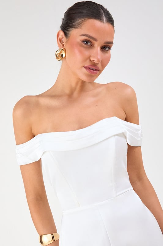 Elegant Bardot neckline with sophisticated folded detail for a striking off-shoulder silhouette
        Luxurious satin fabric that catches the light beautifully as you move
        Flattering structured bodice that enhances your natural shape
        Dramatic wide leg design offering both comfort and statement style
        Floor-sweeping length perfect for creating a statuesque appearance
    
    Command attention at your next special occasion in this show-stopping Misspap jumpsuit. The striking Bardot neckline frames your dcolletage whilst the structured bodice creates a flattering silhouette that transitions into flowing wide legs for dramatic effect. Style with statement earrings and sleek heels as seen on our model for maximum impact at formal events. This versatile piece works brilliantly for weddings, graduation ceremonies or evening soires - simply switch up your accessories to suit the occasion. For cooler evenings, layer with a tailored blazer or delicate wrap without compromising on glamour. The all-in-one design offers effortless sophistication whilst ensuring you stand out from the crowd.