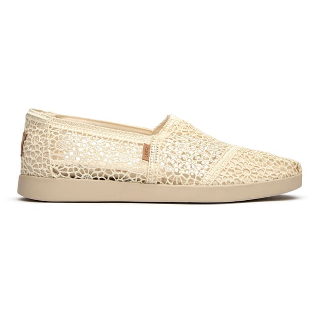 These canvas espadrilles blend TOMS' signature comfort with elevated style that works from weekend coffee runs to evening strolls. The natural canvas upper brings an effortless, lived-in feel while the durable rubber sole provides reliable grip and cushioning. Built on the beloved Alpargata silhouette, they're the kind of versatile flats that become your go-to for practically everything.