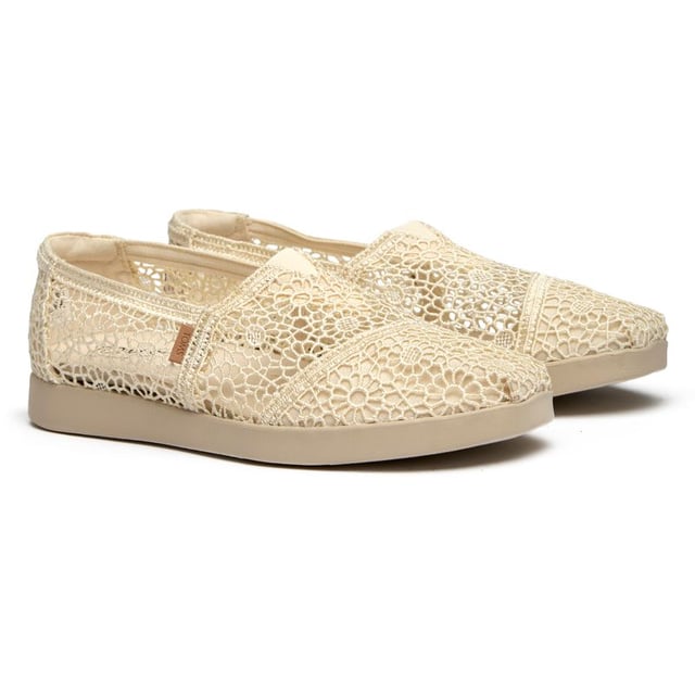 These canvas espadrilles blend TOMS' signature comfort with elevated style that works from weekend coffee runs to evening strolls. The natural canvas upper brings an effortless, lived-in feel while the durable rubber sole provides reliable grip and cushioning. Built on the beloved Alpargata silhouette, they're the kind of versatile flats that become your go-to for practically everything.