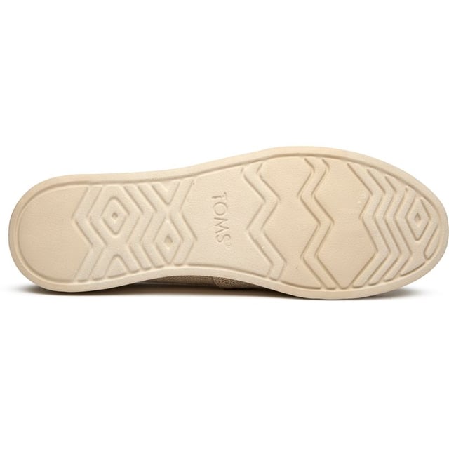 These canvas espadrilles blend TOMS' signature comfort with elevated style that works from weekend coffee runs to evening strolls. The natural canvas upper brings an effortless, lived-in feel while the durable rubber sole provides reliable grip and cushioning. Built on the beloved Alpargata silhouette, they're the kind of versatile flats that become your go-to for practically everything.
