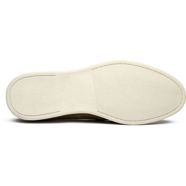 The Simon Carter Tanius Slip On brings style to contemporary menswear with its rich green suede construction and dinosaur print lining. These premium loafers feature luxurious leather sock and lining for all-day comfort, while the durable rubber sole ensures reliable traction. Complete with an exclusive branded shoe bag, they're perfect for the modern gentleman who appreciates distinctive details and museum-quality craftsmanship.