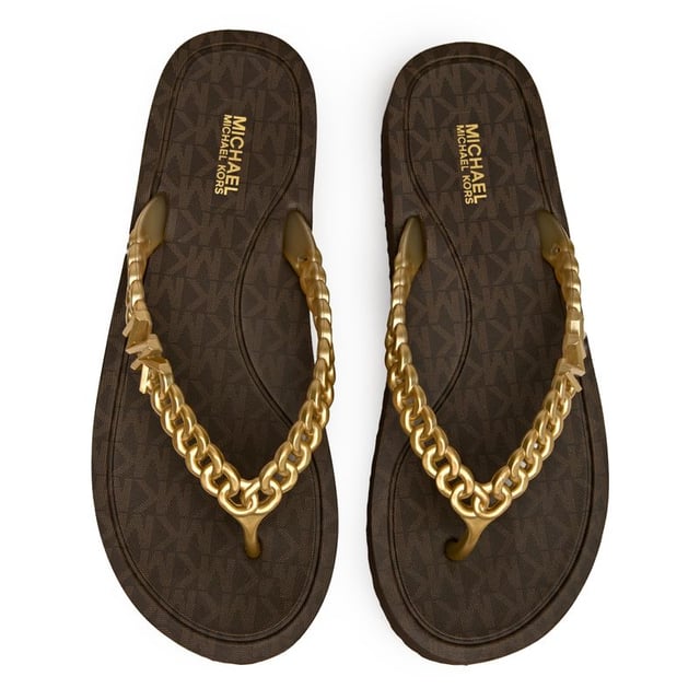 The Michael Kors Zaza brings luxe poolside vibes with its distinctive chain-effect straps that catch the light beautifully. These sleek brown slides feature durable PVC uppers and grippy rubber soles, making them perfect for everything from resort lounging to casual city strolls. The subtle MK branding adds that signature designer touch without being overpowering.