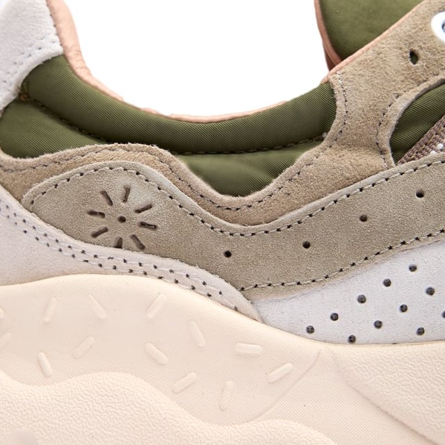 Discover the Flower Mountain Yamano 3, a distinctive running-inspired trainer that blends functionality with natural elements. The lush green colorway showcases premium suede and nylon construction, while leather lining offers superior comfort against your feet. Natural cork antibacterial insoles provide a fresh feel all day long. Thoughtful details like nylon pull tabs and the signature branded leather patch elevate these lightweight trainers, supported by a responsive EVA midsole and durable rubber outsole.