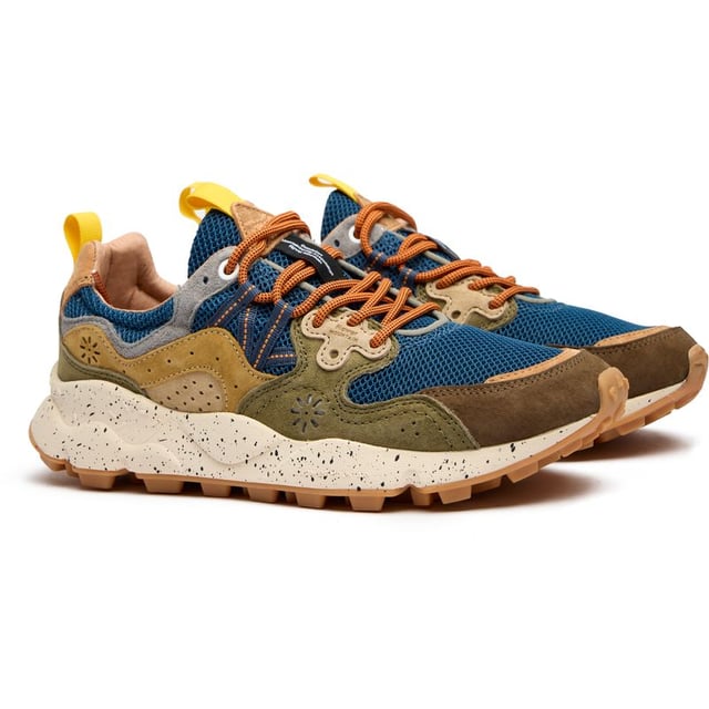 Flower Mountain Yamano 3 Trainers Flower Mountain Yamano 3 combines outdoor ruggedness with urban style in this distinctive blue runner. The thoughtful blend of nylon and suede creates a textured upper that stands out, while the leather patch adds a touch of premium branding. Performance meets comfort with natural cork insoles that fight odor-causing bacteria, and the lightweight EVA midsole delivers exceptional cushioning. Practical pull tabs on the heel and tongue make these easy to slip on when adventure calls. The perfect balance of functional design and distinctive Japanese-inspired aesthetics.