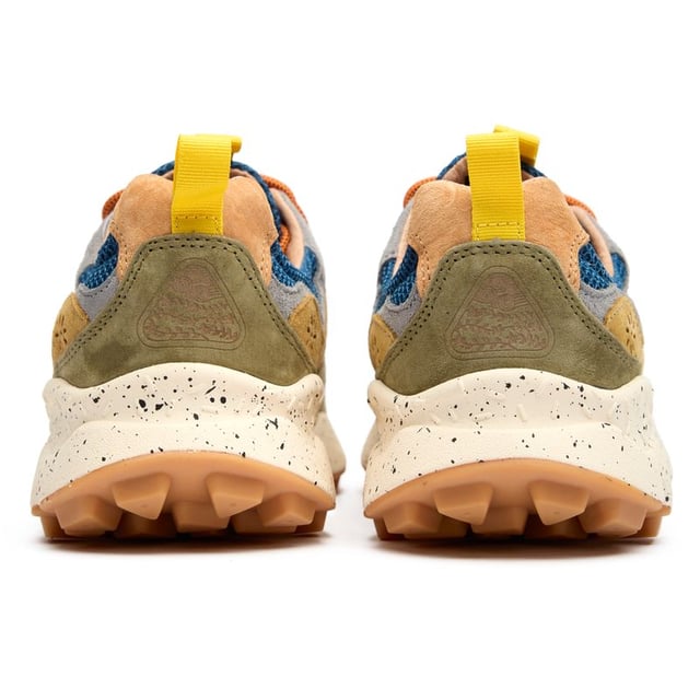 Flower Mountain Yamano 3 Trainers Flower Mountain Yamano 3 combines outdoor ruggedness with urban style in this distinctive blue runner. The thoughtful blend of nylon and suede creates a textured upper that stands out, while the leather patch adds a touch of premium branding. Performance meets comfort with natural cork insoles that fight odor-causing bacteria, and the lightweight EVA midsole delivers exceptional cushioning. Practical pull tabs on the heel and tongue make these easy to slip on when adventure calls. The perfect balance of functional design and distinctive Japanese-inspired aesthetics.