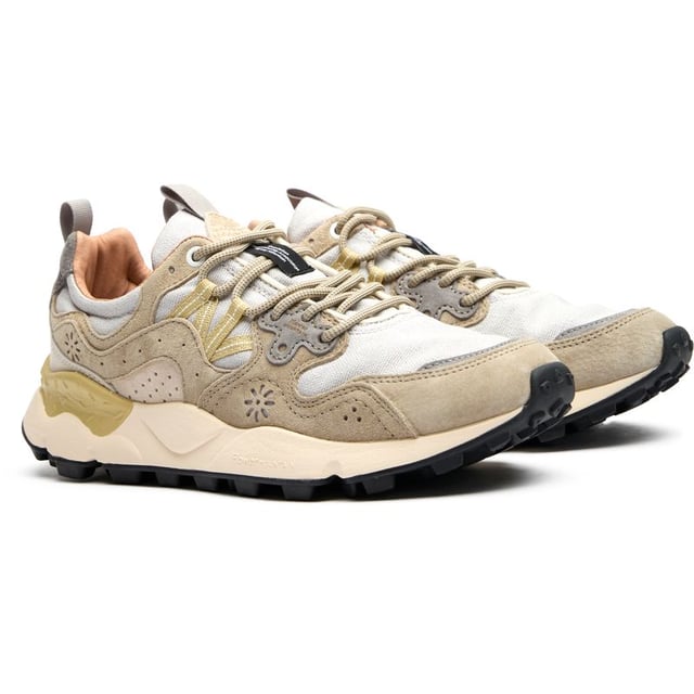 The Flower Mountain Yamano 3 Uni trainers blend outdoor inspiration with contemporary design. Crafted with premium nylon and suede uppers, these natural-toned running-style shoes deliver both durability and style. The distinctive branded leather patch adds character, while cork antibacterial insoles provide natural freshness. Practical touches include convenient pull tabs and a lightweight EVA midsole/rubber sole combination that ensures all-day comfort. Perfect for the urban explorer who values Japanese-inspired quality craftsmanship and understated aesthetics.