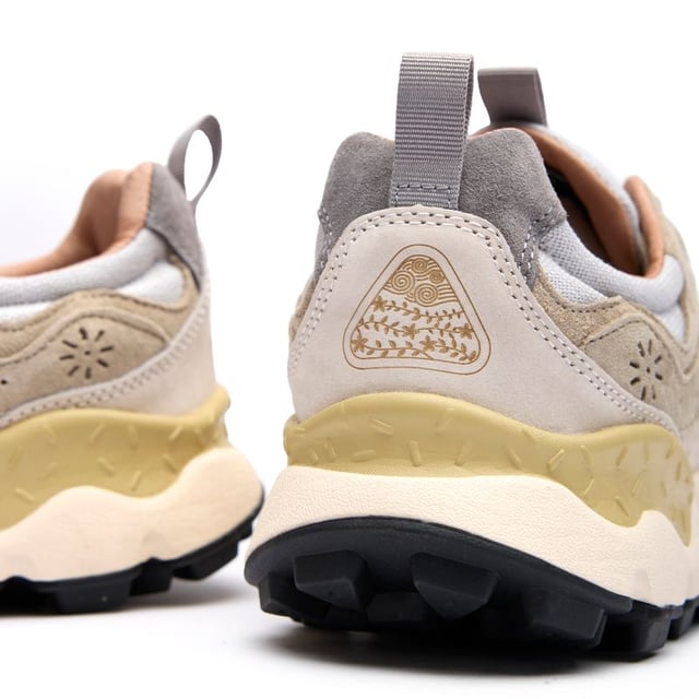 The Flower Mountain Yamano 3 Uni trainers blend outdoor inspiration with contemporary design. Crafted with premium nylon and suede uppers, these natural-toned running-style shoes deliver both durability and style. The distinctive branded leather patch adds character, while cork antibacterial insoles provide natural freshness. Practical touches include convenient pull tabs and a lightweight EVA midsole/rubber sole combination that ensures all-day comfort. Perfect for the urban explorer who values Japanese-inspired quality craftsmanship and understated aesthetics.