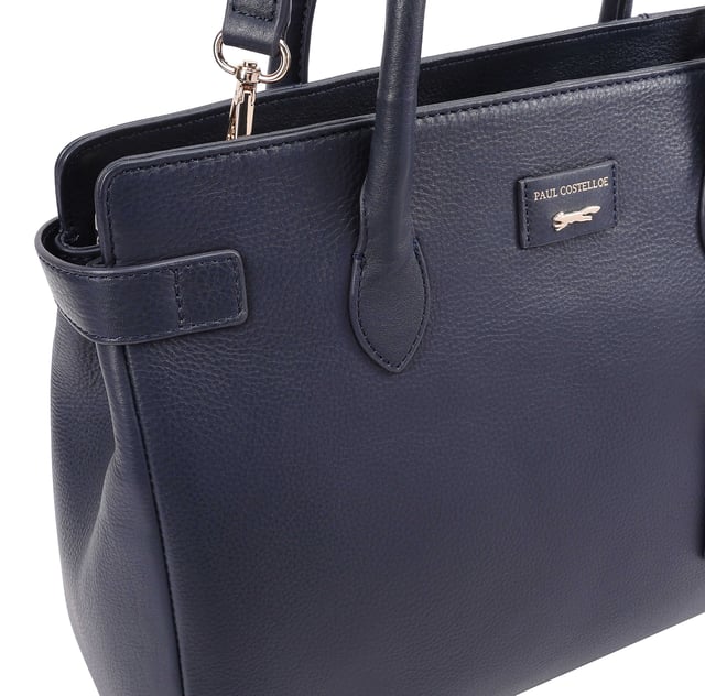 Crafted from soft premium leather, this elegant work bag combines style with functionality. Its spacious central compartment is smartly organized with slip and zipped pockets on both internal walls, while a padded section keeps your gadget safe. A top zip secures the contents, and a handy back slip pocket adds extra convenience. Carry it your way with the removable, adjustable shoulder strap, and enjoy the added touch of sophistication with a branded luggage tag accessory.