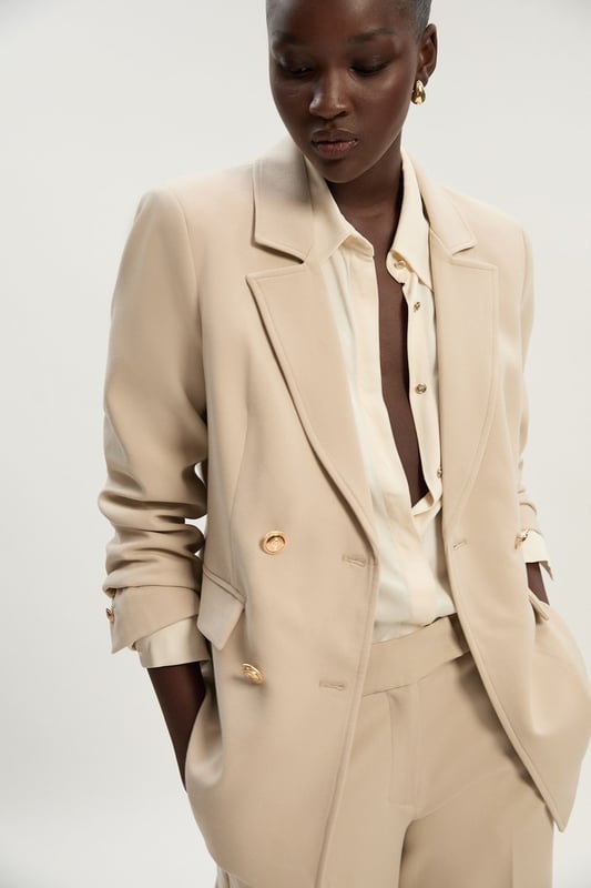 A sculptural rendition of the classic blazer, this piece offers endless sophistication. Sharp tailoring and double-breasted buttons create a cinched silhouette, while classic notched lapels and flap pockets add a traditional touch. Style this blazer with co-ordinating tailored trousers for a powerful ensemble, or size up for a contemporary, oversized aesthetic.Notched collarDouble breastedTailored Browse this seasons suits now.