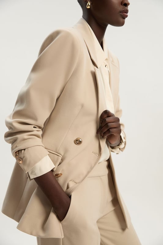 A sculptural rendition of the classic blazer, this piece offers endless sophistication. Sharp tailoring and double-breasted buttons create a cinched silhouette, while classic notched lapels and flap pockets add a traditional touch. Style this blazer with co-ordinating tailored trousers for a powerful ensemble, or size up for a contemporary, oversized aesthetic.Notched collarDouble breastedTailored Browse this seasons suits now.
